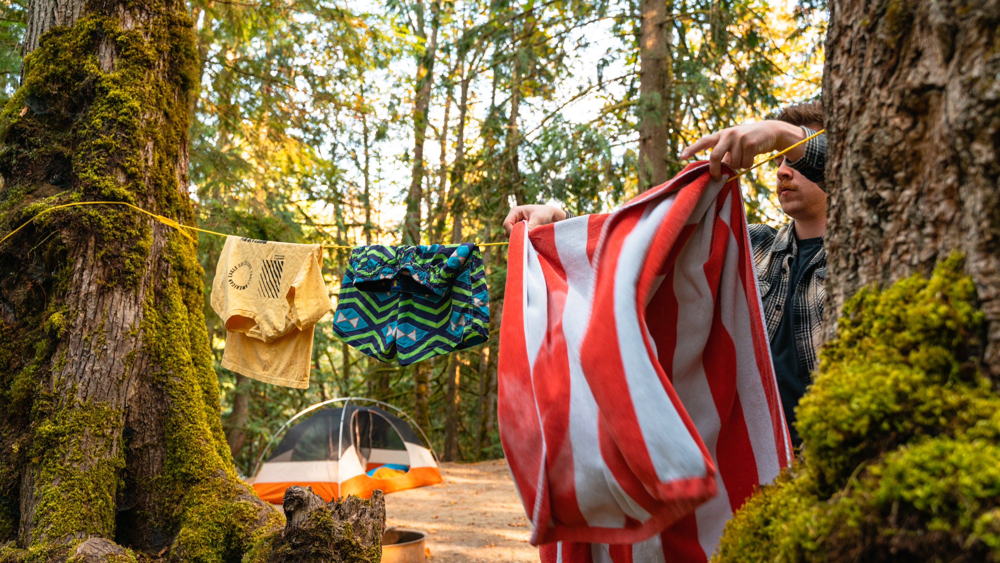 Male putting towel on a clothesline